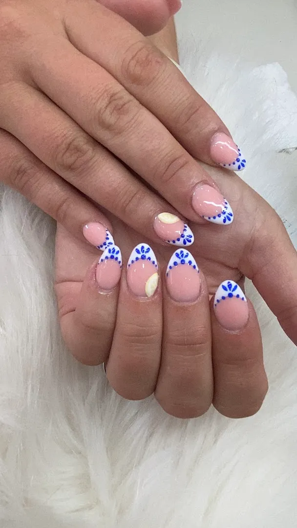 Hand-painted delft-blue folk art on white french tips, by Nails First Garston