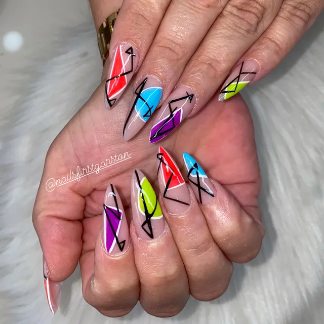Bold abstract line art in red, purple and black on long nails