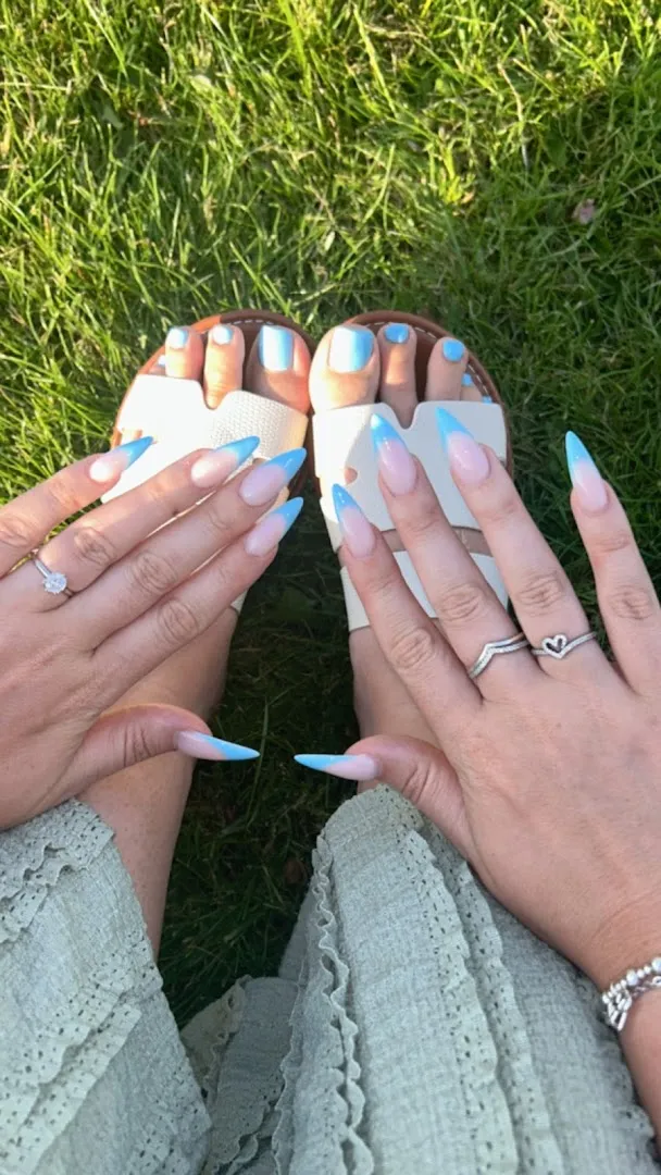 Matching blue-tip french manicure and pedicure in the sunshine
