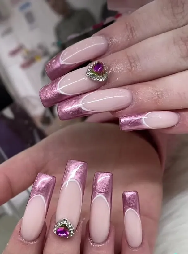 Pink chrome french tips with a crystal heart gem