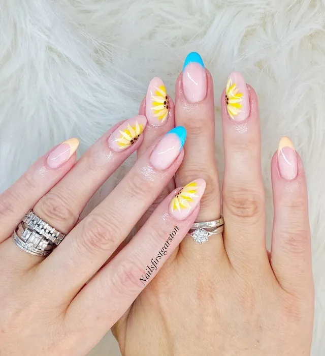 Yellow floral nail art with sky-blue tips